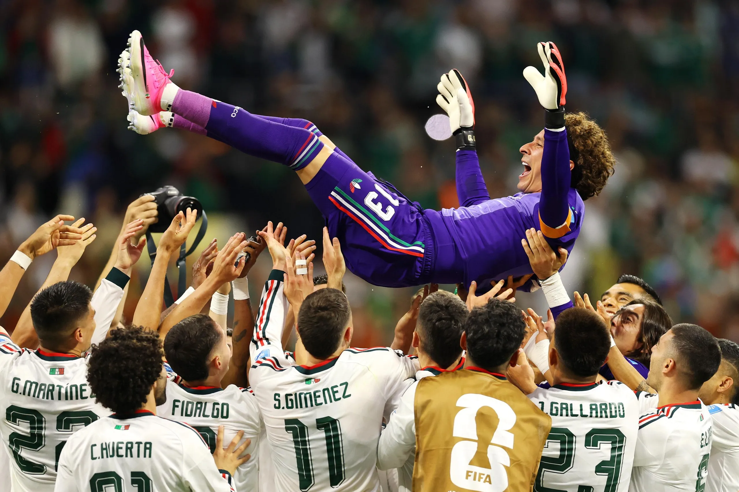 Guillermo Ochoa is tossed into the air by his teammates after Mexico's victory.