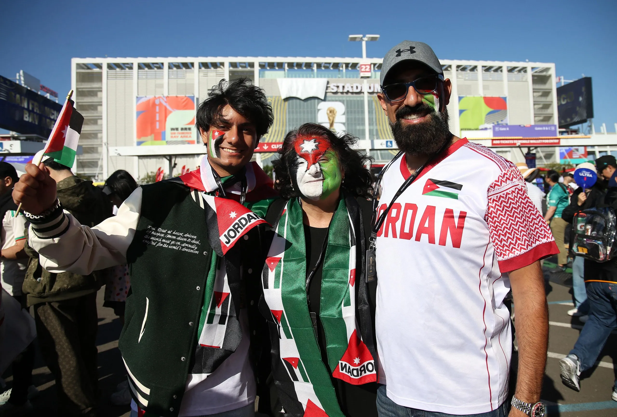 Jordan fans pose for a photo outside the stadium.