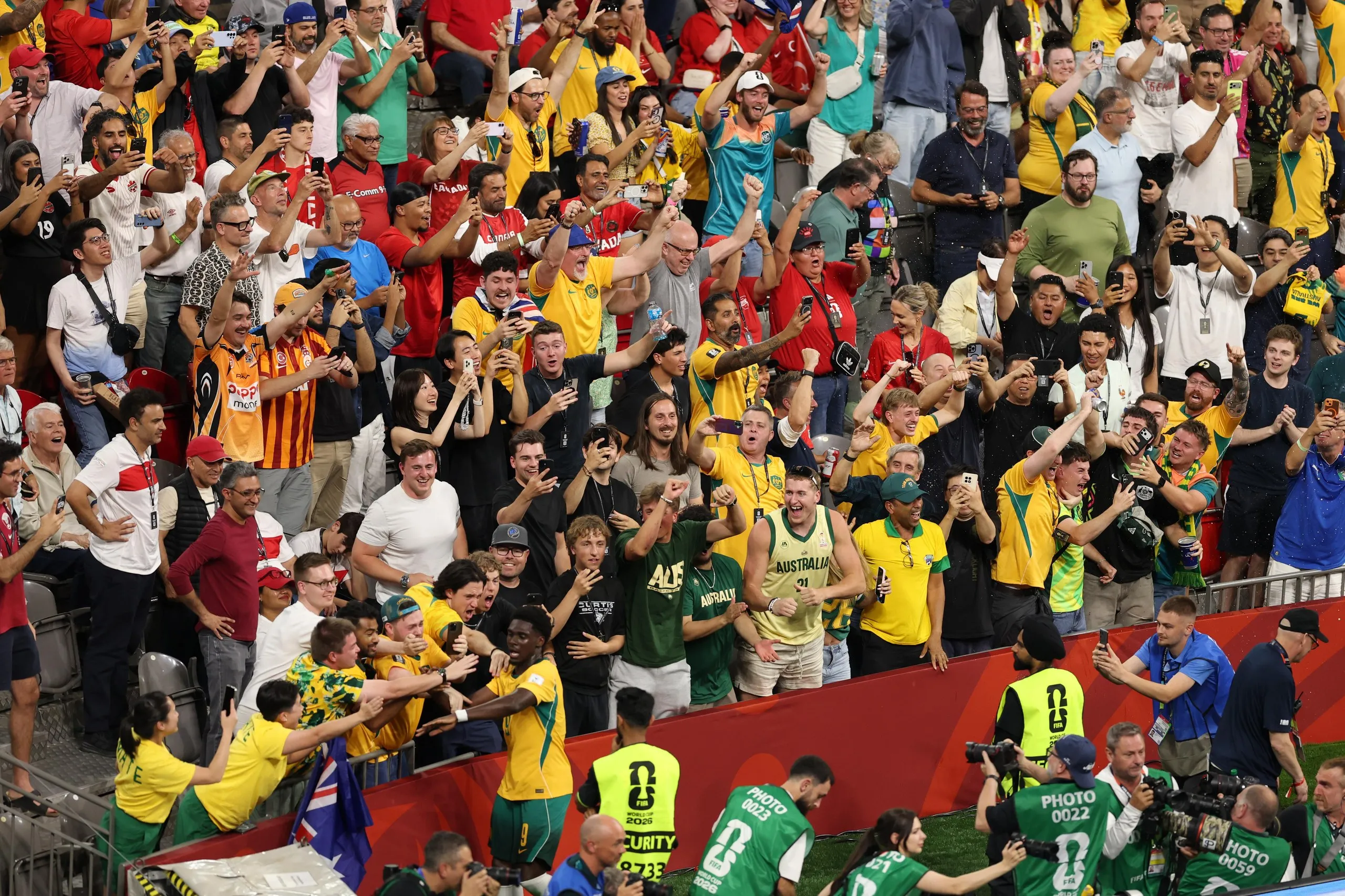 Toure celebrates with Socceroos fans after the second goal went in against Turkey.