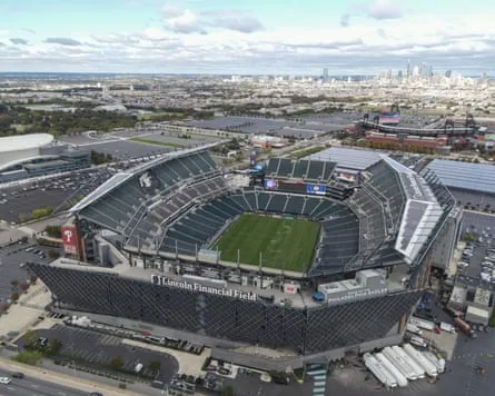 An aerial view of Lincoln Financial Field with the Philadelphia skyline in the background.