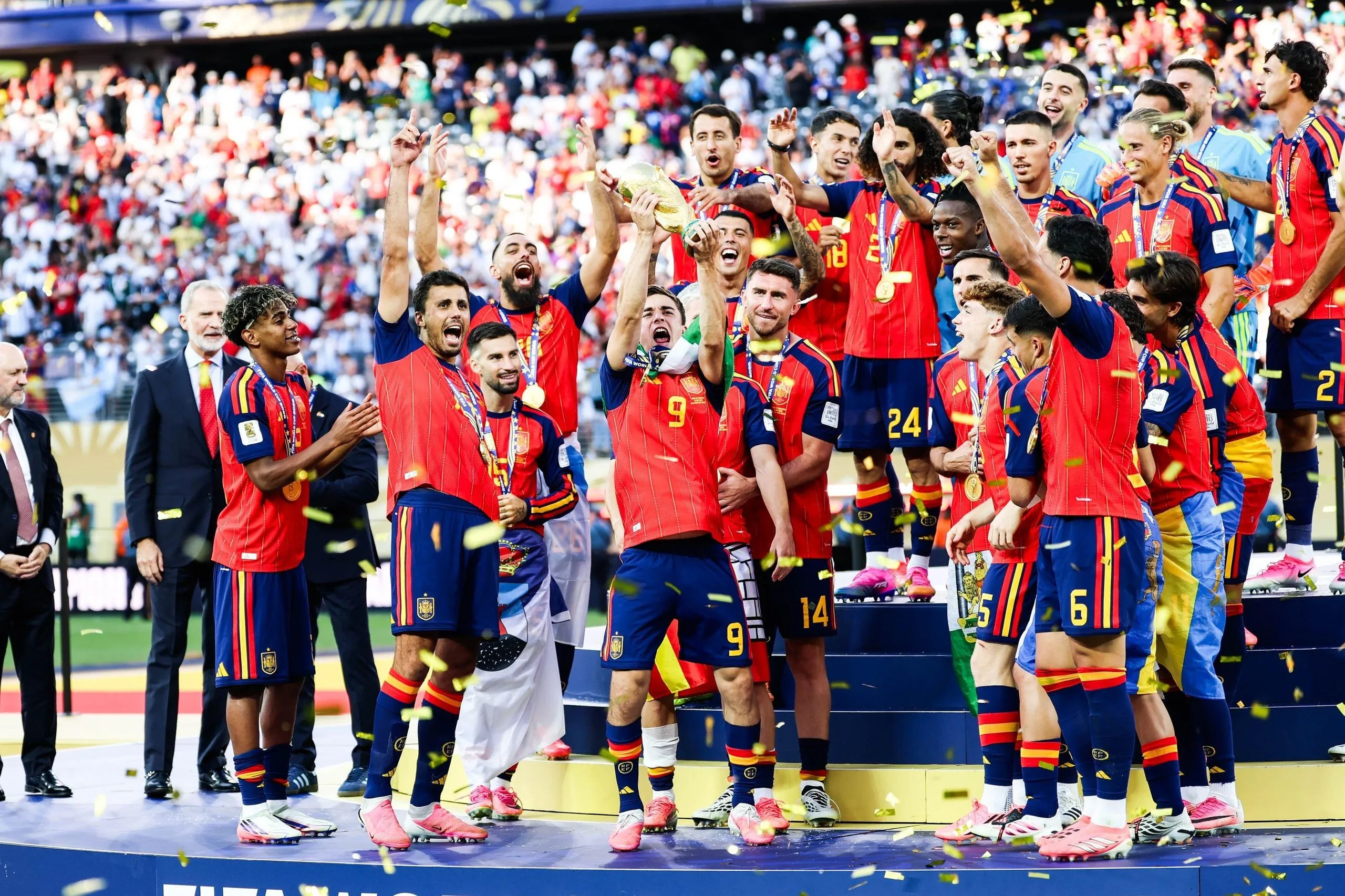 Gavi lifts the World Cup trophy while surrounded by his jubilant Spain teammates