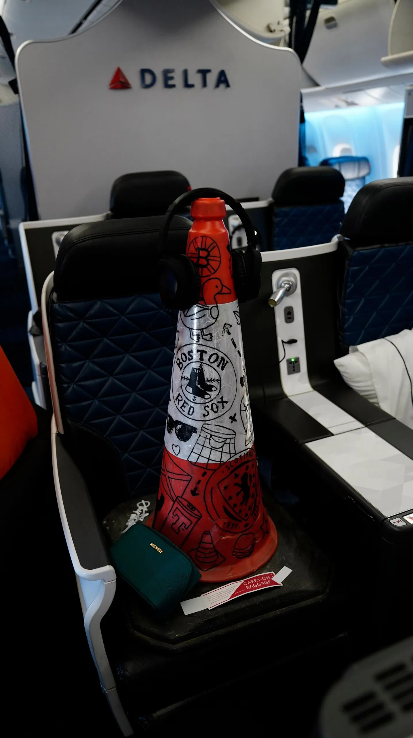 An orange traffic cone on a seat.