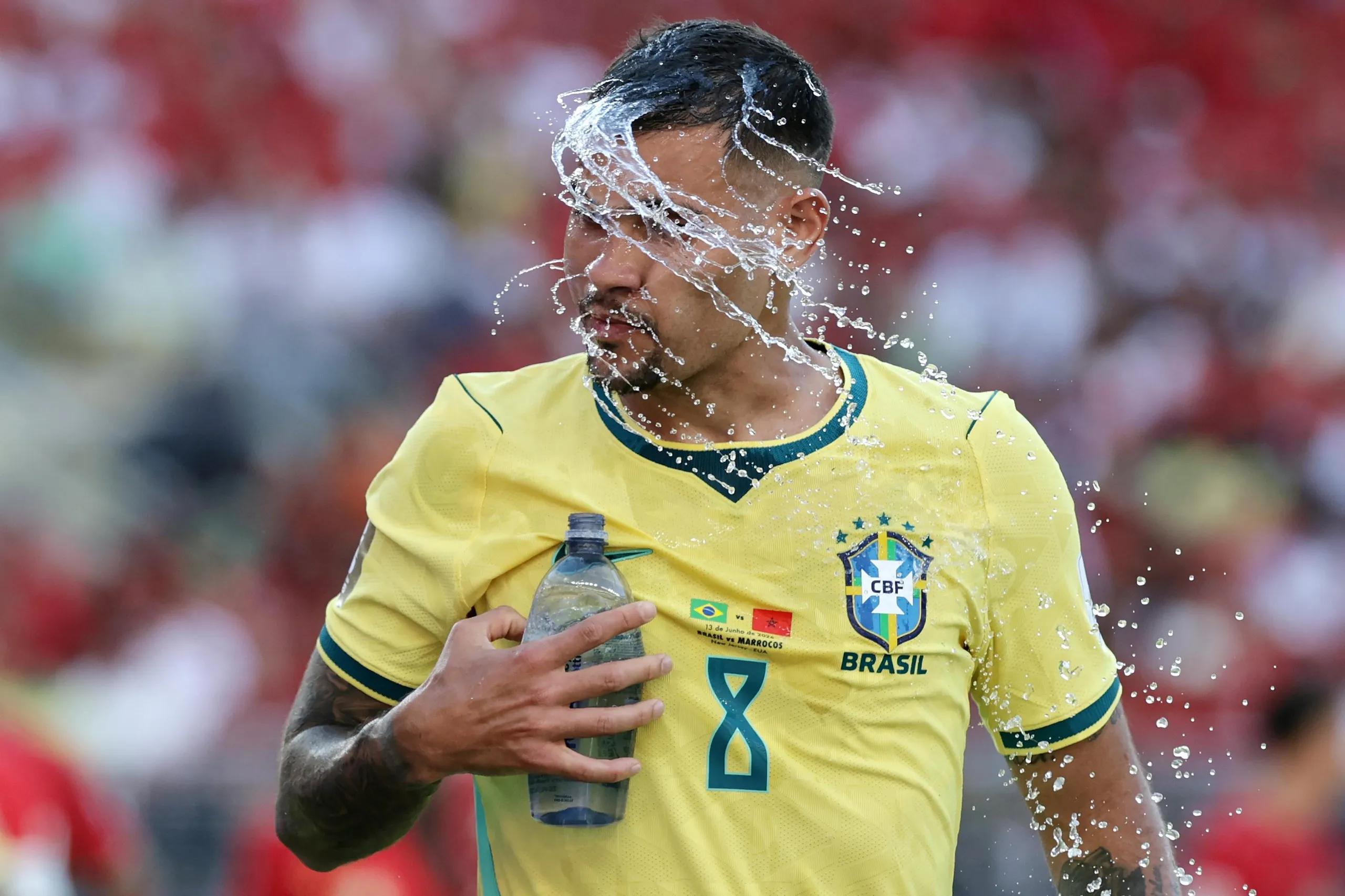 Brazil’s Bruno Guimarães cools down with a splash of water in the first half against Morocco in New Jersey.