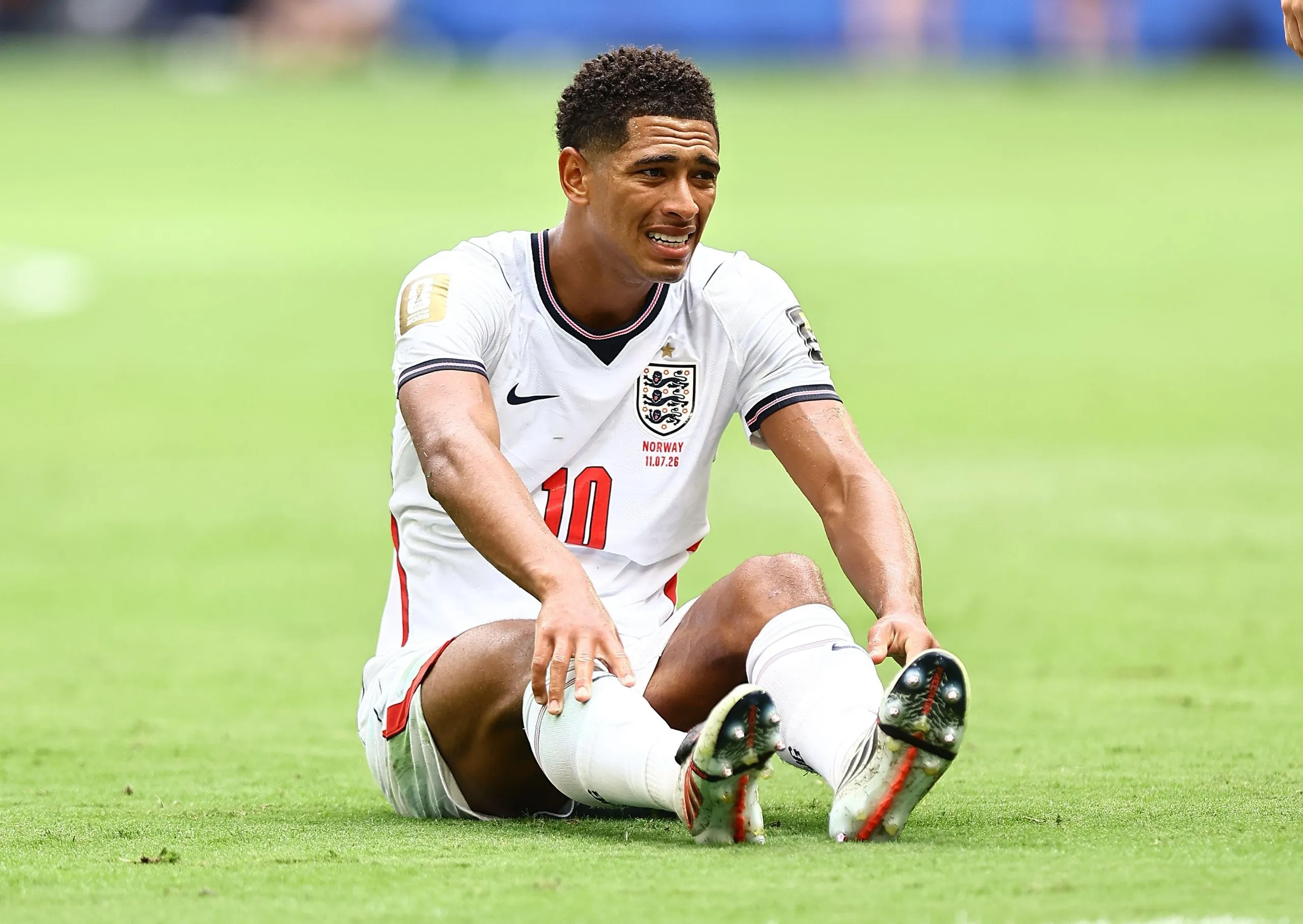 Jude Bellingham sits on the pitch, exhausted