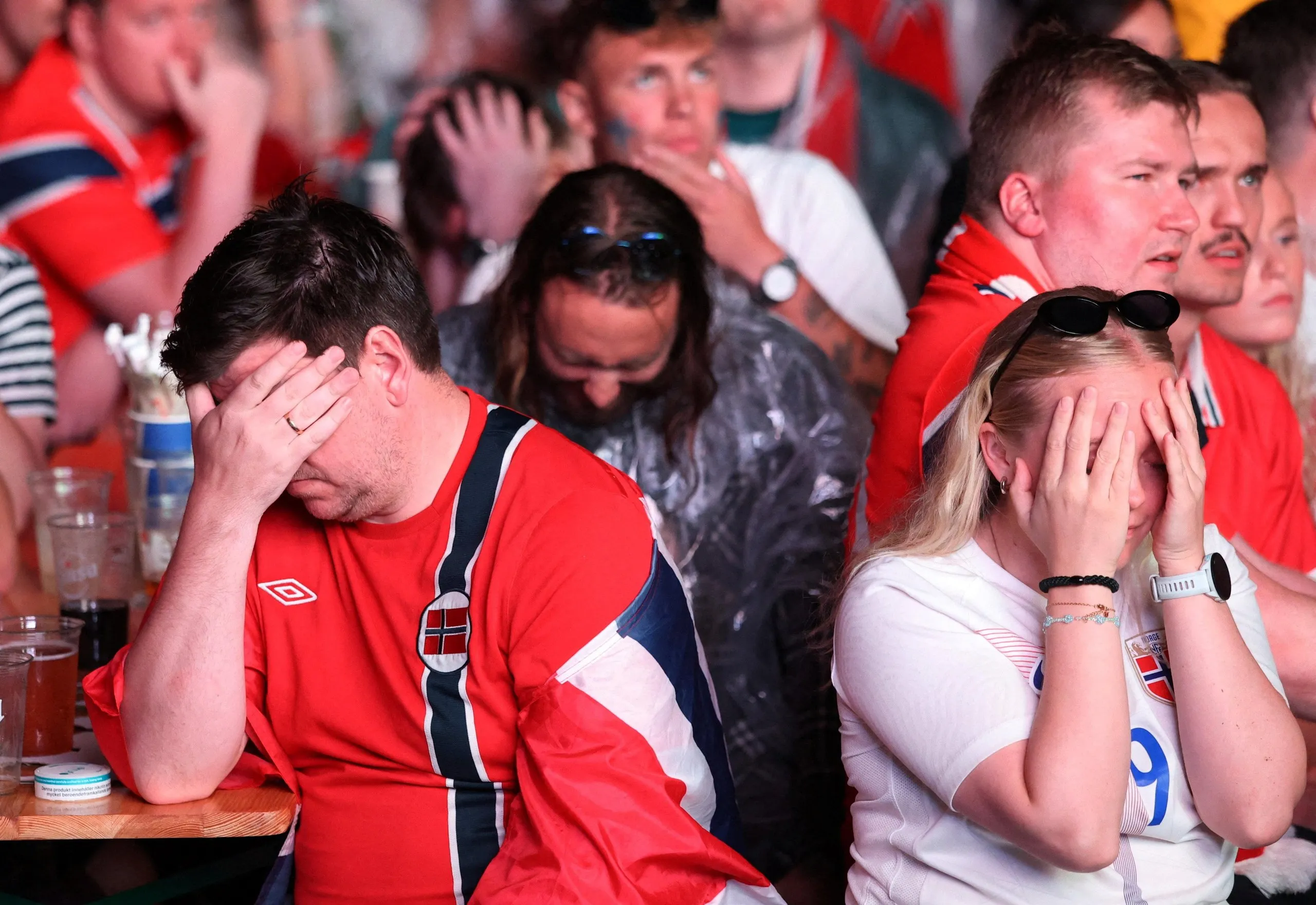 Norway fans gathered in Oslo cover their facces during their team’s defeat to England