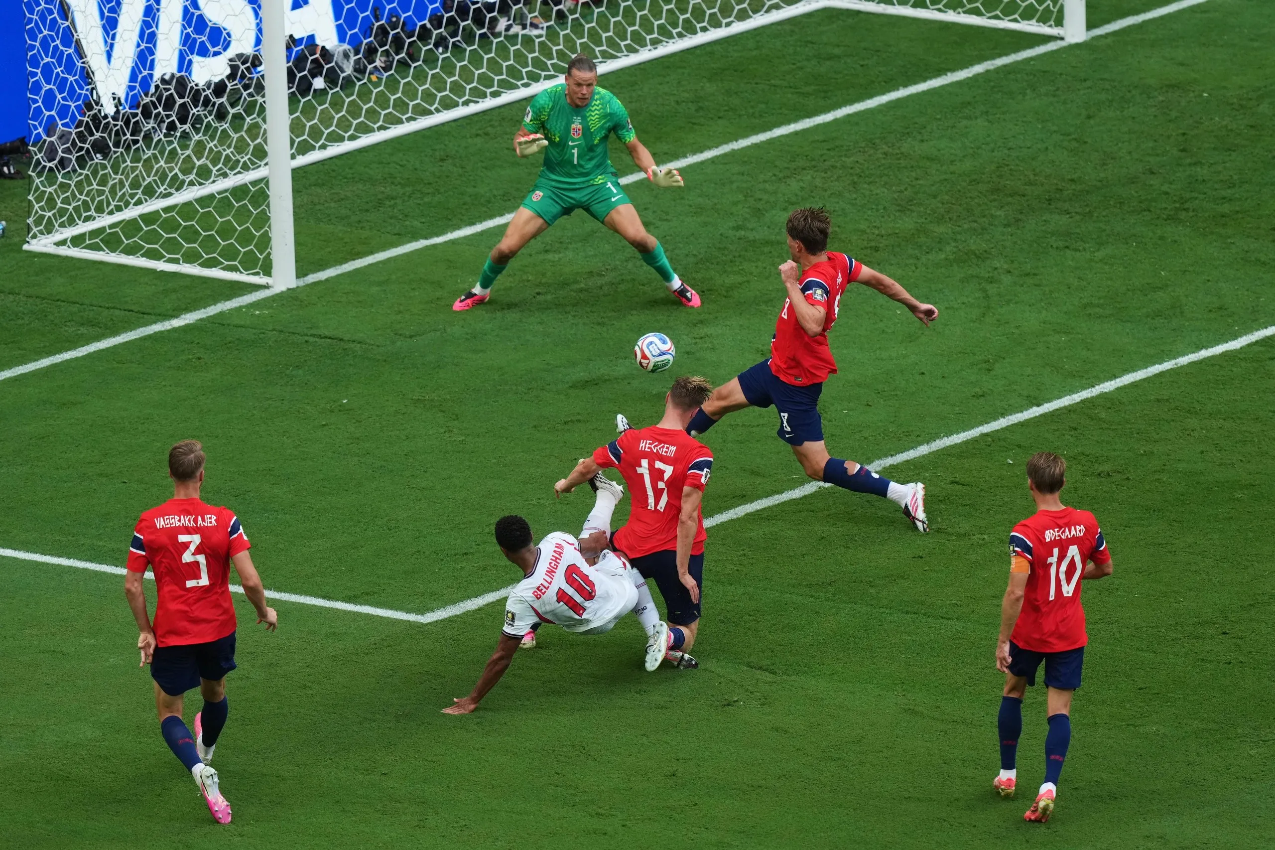 Jude Bellingham holds off the challenge of Torbjørn Heggem to score