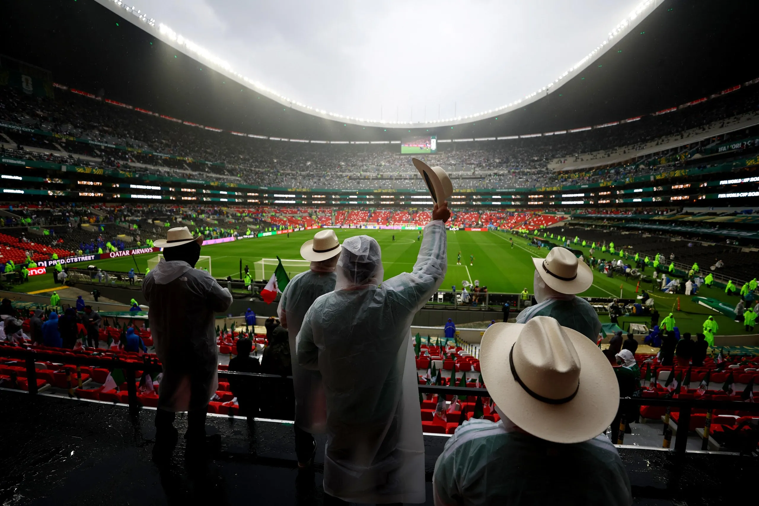 Mexico fans wear rain ponchos inside the Azteca before the match against England